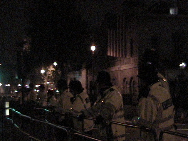 Police in front of American flag hanging from the Horse Guard