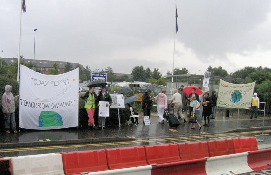 “Protesters hand out leaflets urging flyers to ‘ReThink’ at Norwich Airport”