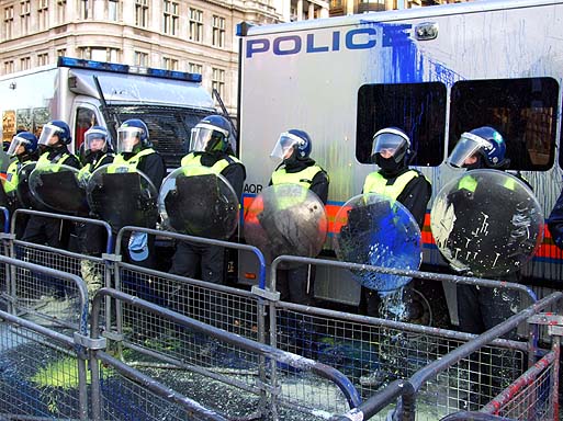 Paintbombed police, in front of Westminster Palace. Note defensive 'cubes'.