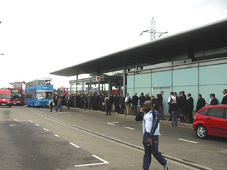 scores of arms fair delegates waiting for replacement buses