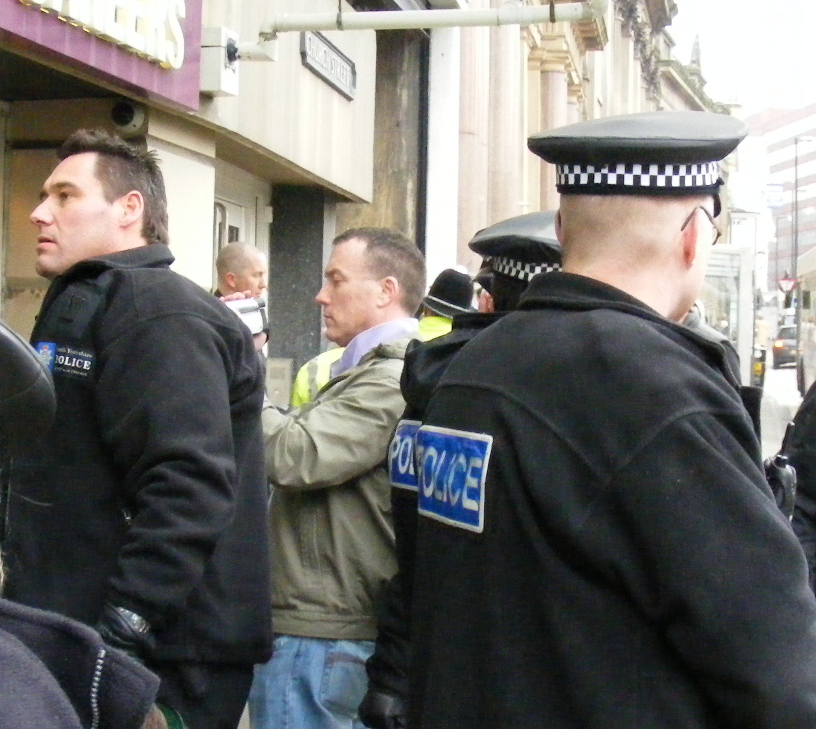 the mystery camera man, rather chummy with the police